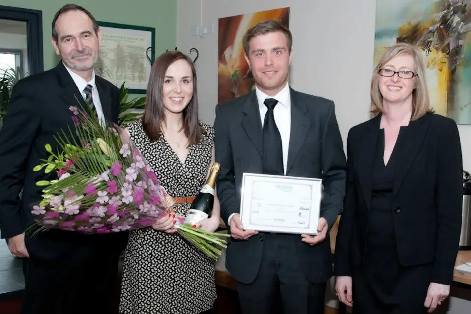 Ed holding the award certificate