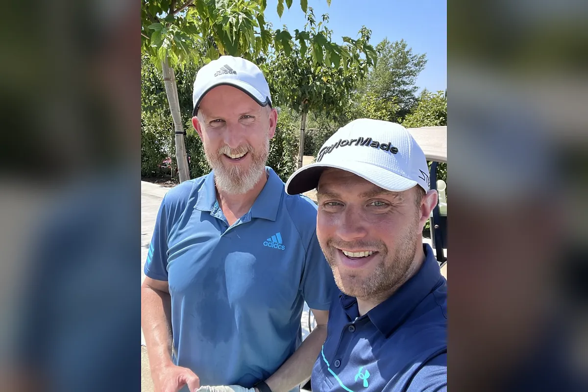 Ed and Chris Evans, co-founders of National Tennis, smiling together on a sunny day