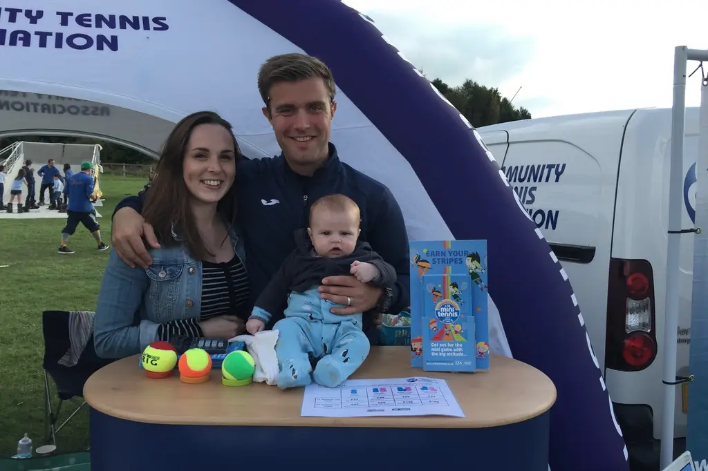 Ed with his wife and son at a Community Tennis Association stand