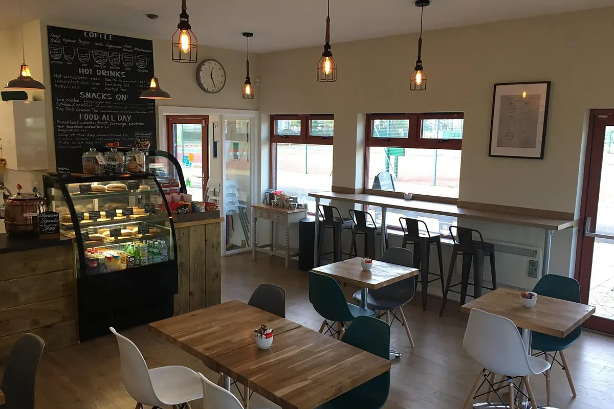 Inside The Park Coffee House, with the menu board, counter and windows onto the courts